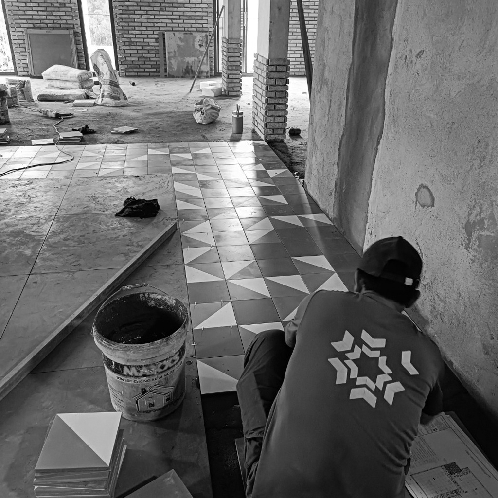 Workers tiling the floor during the office fit-out process